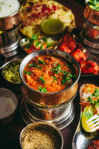 a pot of food on a table with other foods at Swahili Beach in Diani Beach