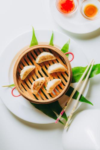 a bowl of food on a plate with chopsticks at Swahili Beach in Diani Beach