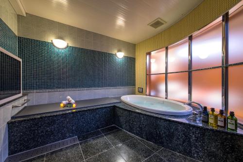 a large bathroom with a tub in a room at HOTEL Dior7 in Hamamatsu