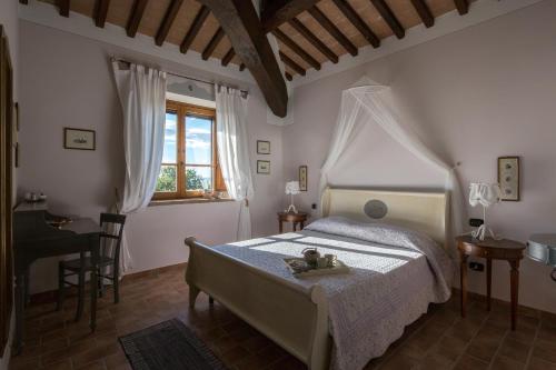 a bedroom with a bed with a teddy bear on it at Villa dei Tramonti in Passignano sul Trasimeno