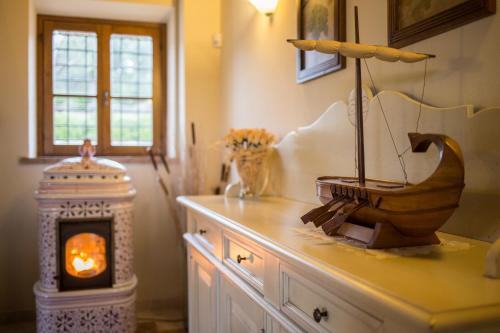 a room with a table with a fireplace and a sewing machine at Villa dei Tramonti in Passignano sul Trasimeno