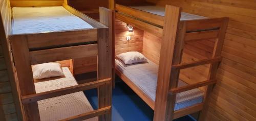 two bunk beds in a wooden room with at Tuksi Health and Sports Centre in Tuksi