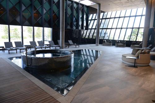a large lobby with a large tub in the middle of a building at Enjoy Punta del Este in Punta del Este