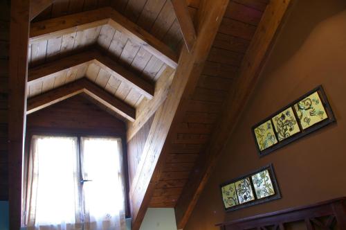 a ceiling with a window and two pictures on the wall at Casa Villamana in Oto