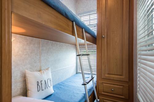 a bunk bed with a ladder in a room at Bethpage Hewick Three-Bedroom Cottage 30 in Urbanna