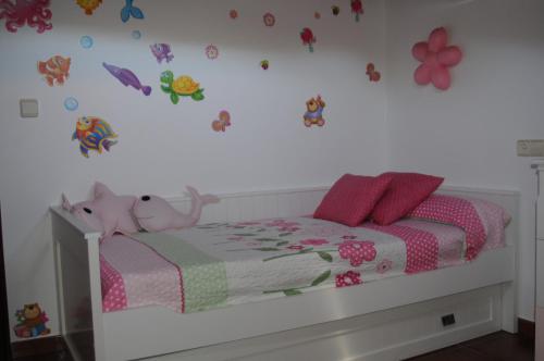 a bedroom with a bed with flowers and butterflies on the wall at Villa Cuesta in O Grove