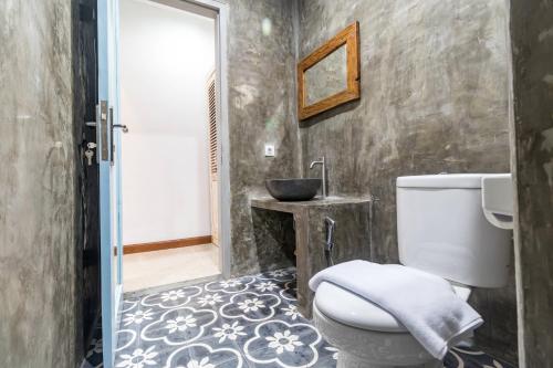 a bathroom with a toilet and a sink at D-Anyar Stay and Surf Canggu in Canggu