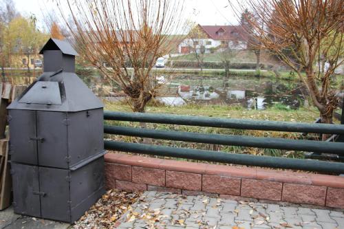 a metal box next to a fence with a yard at Chalupa u rybníka Čistá u Horek in Čistá u Horek