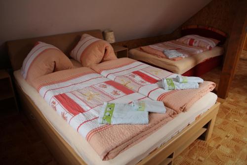 two twin beds with towels and pillows on them at Chalupa u rybníka Čistá u Horek in Čistá u Horek