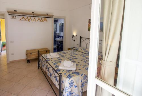a bedroom with a bed and a room with a bathroom at Casa Galano in Cetara