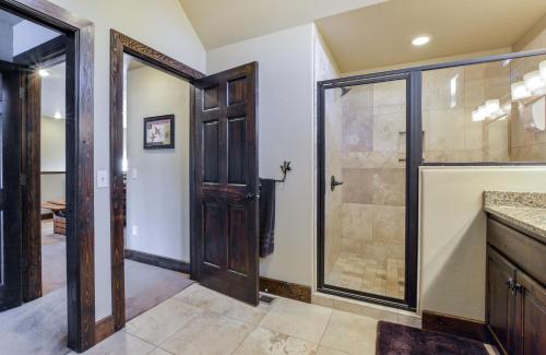 a bathroom with a shower and a glass door at Chalets Resort Luxury Lakefront Villa Amazing View 2 Pools Free Amenities Dock in Lampe
