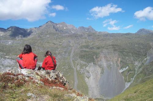 two people sitting on top of a mountain at Casa Villamana in Oto