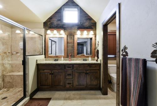a bathroom with a sink and a shower and a toilet at Luxury Lakefront Villa 2Mi to Silver Dollar City POOL Theatre Room Kayaks in Branson