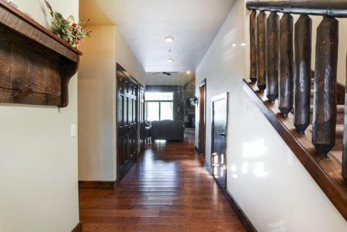 a long hallway with wood flooring and a hallway with wooden doors at 8 Bed Luxury Lakefront Villa Amazing View 2 Pools Free Resort Amenities Dock in Lampe