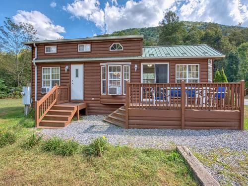 a log cabin with a porch and a deck at Maggie Valley Cabin Rentals in Maggie Valley