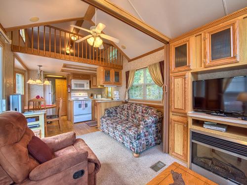 a large living room with a couch and a tv at Maggie Valley Cabin Rentals in Maggie Valley