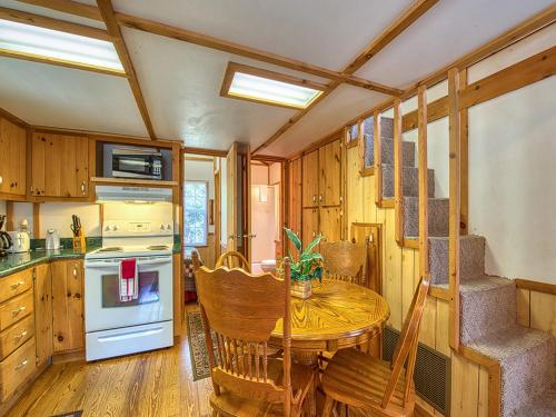 a small kitchen with a table and a stove at Maggie Valley Cabin Rentals in Maggie Valley