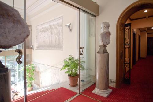 a room with a glass door with a plant in it at Aldrovandi Residence City Suites in Rome
