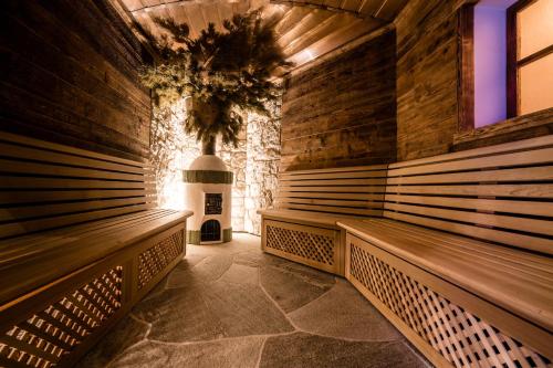 a row of benches in a room with a fireplace at Hotel Sun Valley in Selva di Val Gardena