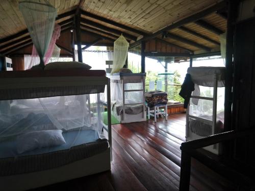 two bunk beds in a room with a wooden floor at Hostel do Morro in Florianópolis