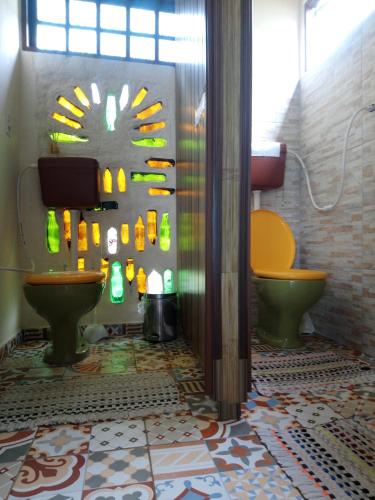 a bathroom with two toilets and a sink at Hostel do Morro in Florianópolis