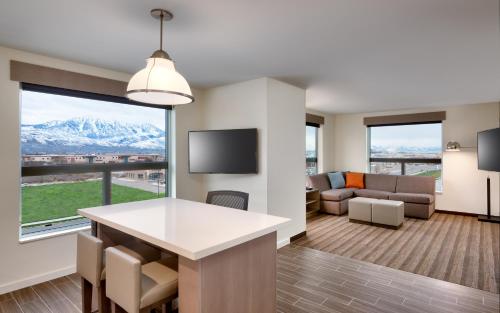 a living room with a large window and a couch at Hyatt House Provo/Pleasant Grove in Pleasant Grove