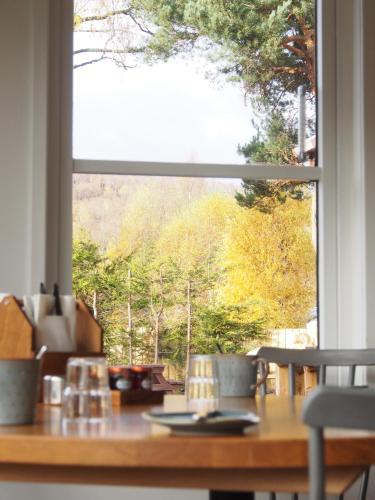 a table with a view of a window at Ravenscraig Guest House in Aviemore