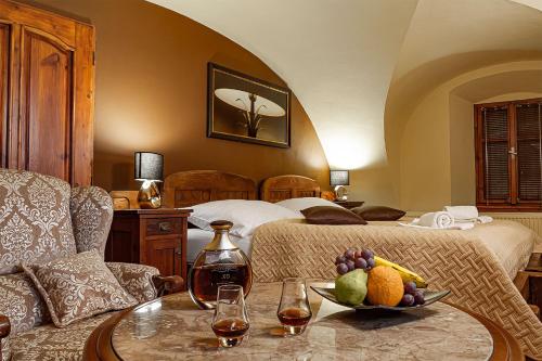 a bedroom with a bed and a bowl of fruit on a table at Penzión Restart House - Spiššská Sobota in Poprad