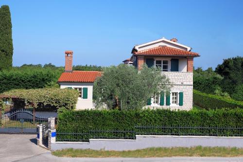 a house with a fence in front of it at Luxury VILLA LE ROSE in Poreč