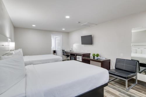 a bedroom with a bed and a desk and a chair at Villa 1565 - Saint Augustine in Saint Augustine
