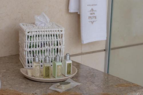a group of four bottles of lotion on a counter at Hotel Boutique Don Pepe in Santa Marta