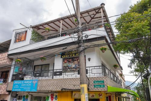 a building with a balcony on the side of it at CAMPO VALDES PARK HOSTEL in Medellín