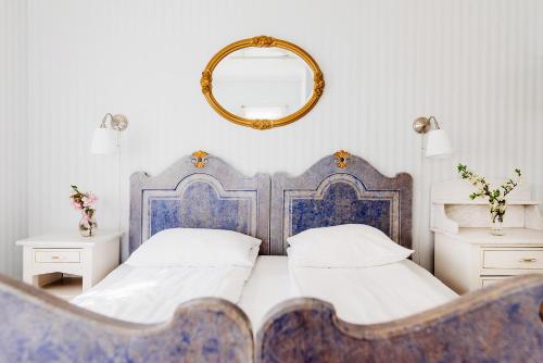 Ένα ή περισσότερα κρεβάτια σε δωμάτιο στο Utne Hotel