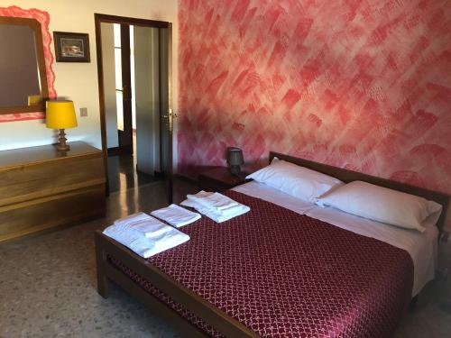 a bedroom with a bed with towels on it at La Tana della Volpe B.&.B. in Montecassiano