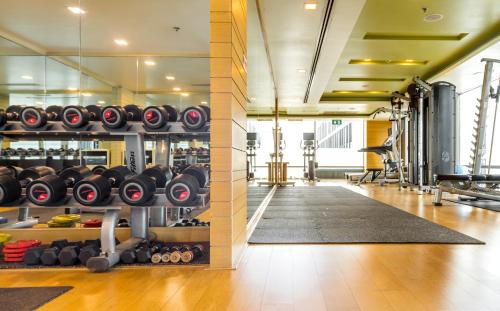 a gym with dumbbells and weights on a wall at Sivatel Bangkok Hotel in Bangkok