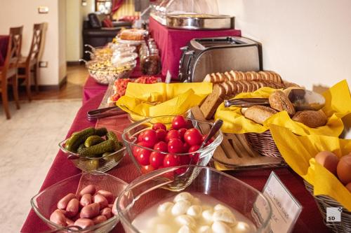 a table topped with lots of different types of food at Hotel Alessandro Della Spina in Pisa