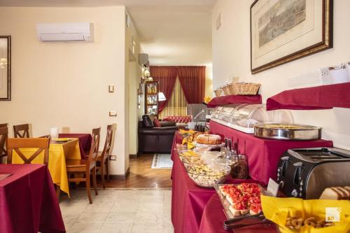 a buffet in a restaurant with purple clothed tables at Hotel Alessandro Della Spina in Pisa