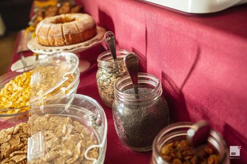 a table topped with jars of food and bread at Hotel Alessandro Della Spina in Pisa