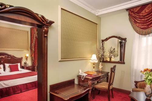 a hotel room with a bed and a desk and a bed and a desk at Staro Hotel in Kyiv