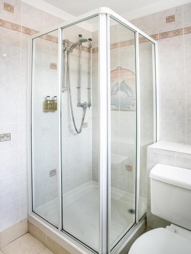 a shower with a glass door in a bathroom at The National Hotel in Dingwall