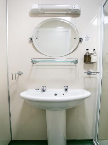 a bathroom with a sink and a mirror at The National Hotel in Dingwall