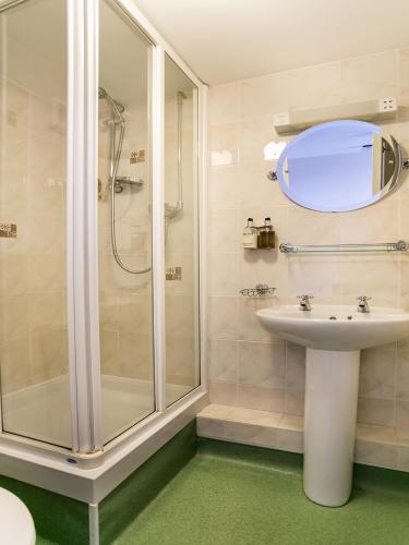 a bathroom with a shower and a sink at The National Hotel in Dingwall