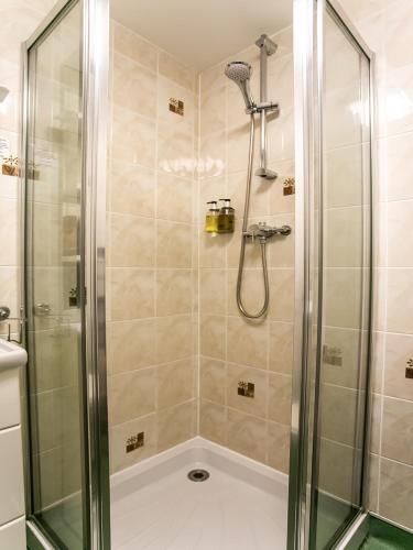 a shower with a glass door in a bathroom at The National Hotel in Dingwall
