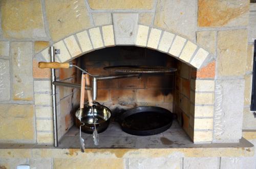a brick oven with a pot inside of it at Chalupa Bohunka in Bouzov