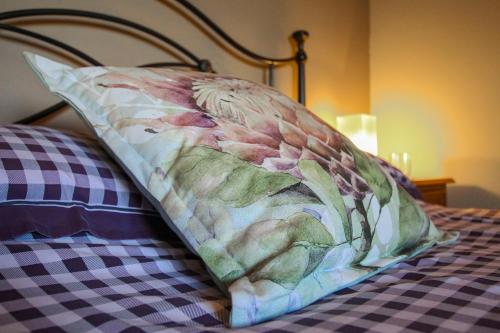 a pillow sitting on top of a bed at Foxhill Fold in Gisburn