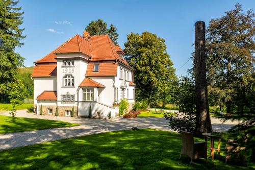 a large house with an orange roof at Villa Adam in Pieszyce