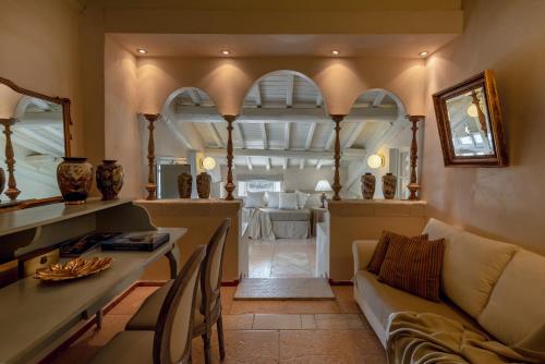 a living room with a couch and a table with vases at Hotel Palazzo Novello in Montichiari