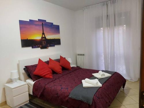 een slaapkamer met een bed met rode kussens en de eiffeltoren bij Hillary E Vale Room in Rome