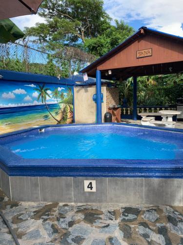 a large swimming pool with a sign on it at Sana El Jardin Secreto in Santiago de los Caballeros