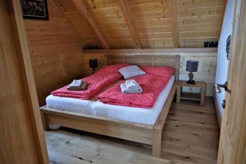 a bedroom with a bed in a wooden cabin at u mistra vichra in Černý Dŭl